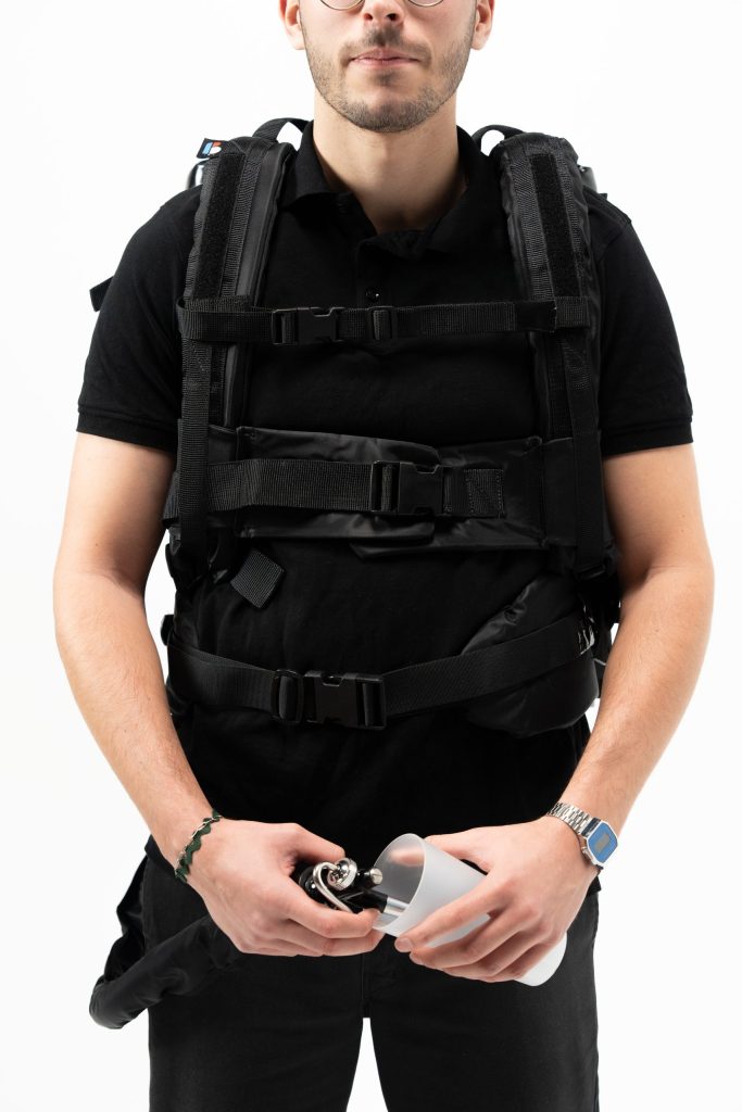 Server using the DraftGo backpack to pour cold soft drinks or draft beer.