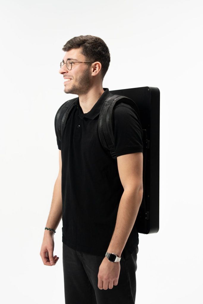 Person wearing a backpack screen for mobile advertising, street marketing, and live event promotions, ergonomic and lightweight design for impactful brand visibility.